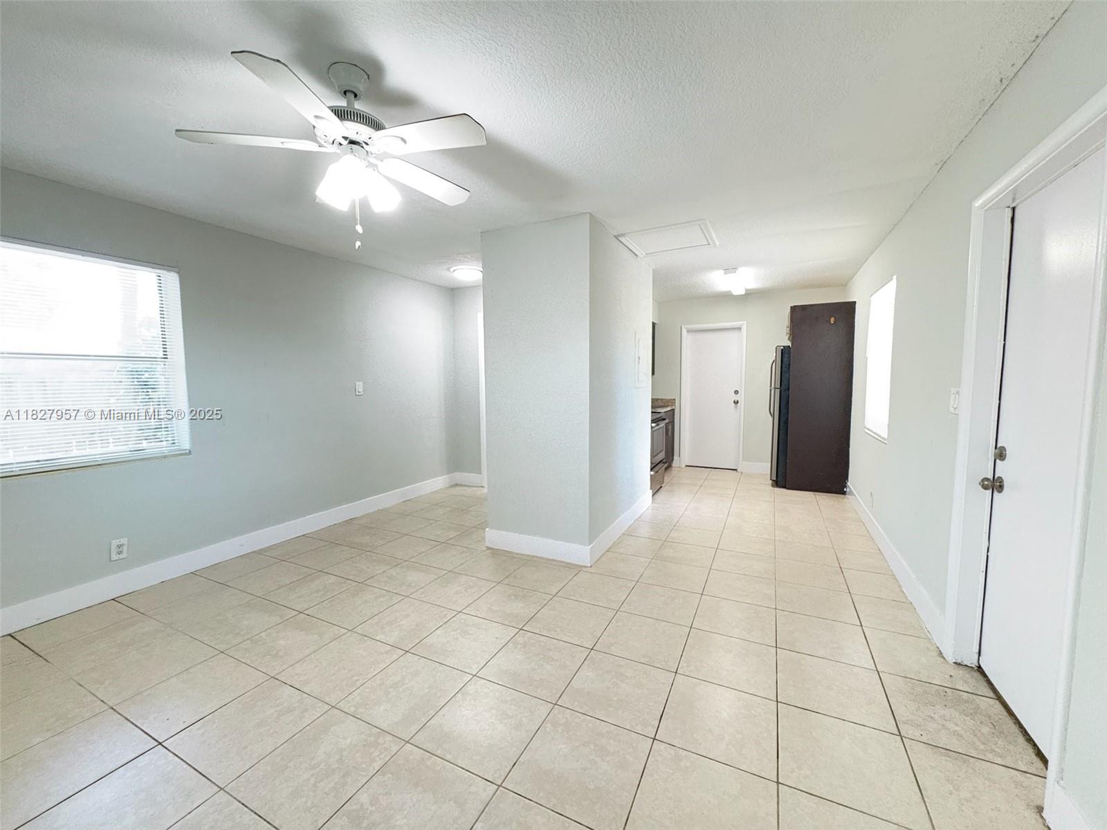 2840 Funston Street, Unit B Hollywood, FL 33020 - Photo 7 of 10 a view of an empty room with window and chandelier fan