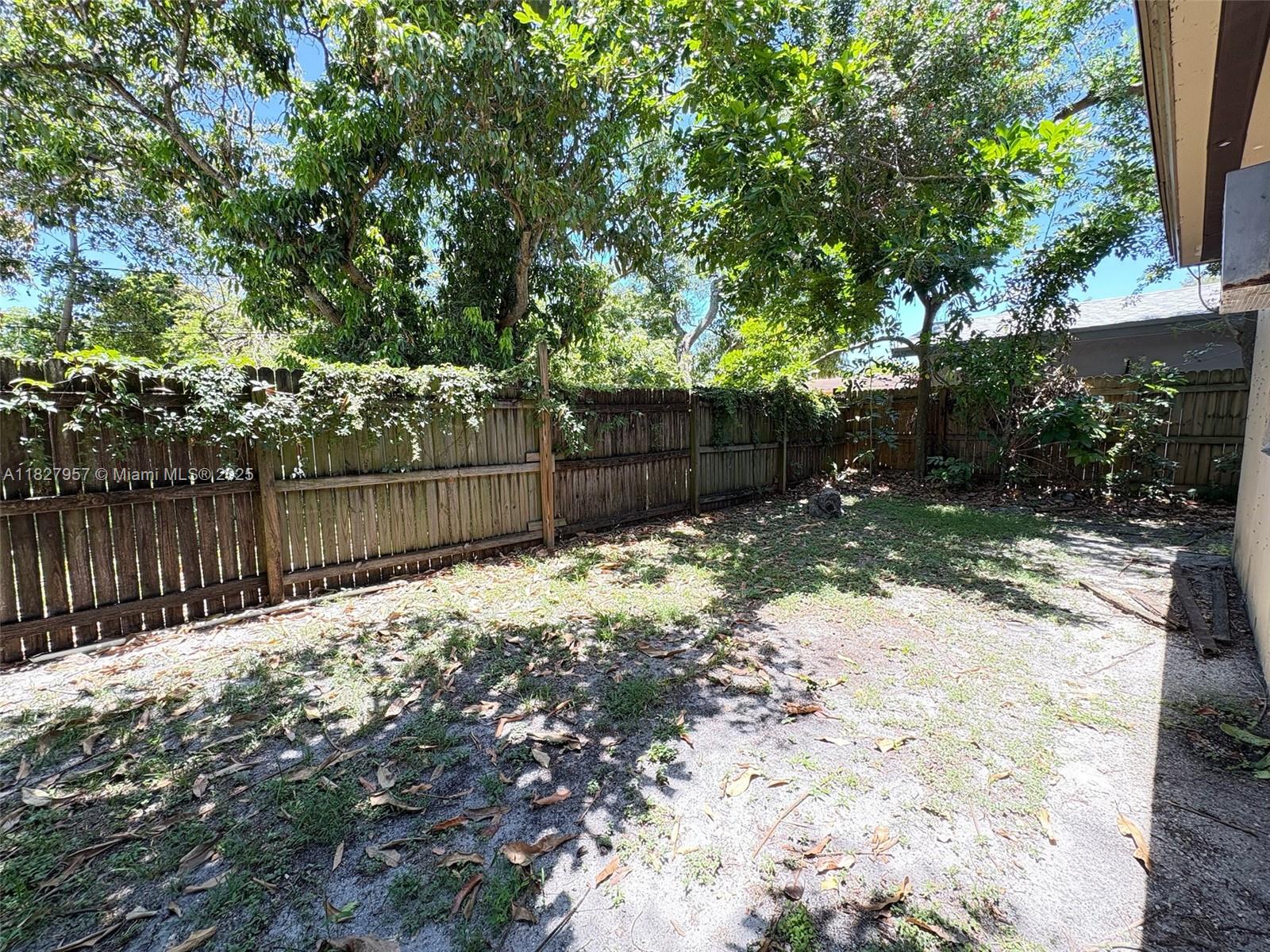 2840 Funston Street, Unit B Hollywood, FL 33020 - Photo 9 of 10 a view of a backyard with tree and wooden fence