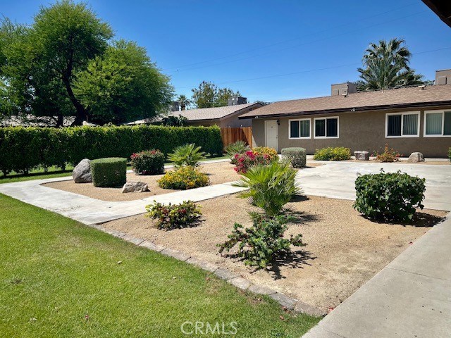73740 Santa Rosa Way, Unit E Palm Desert, CA 92260 - Photo 5 of 15 a view of a house with yard and sitting area