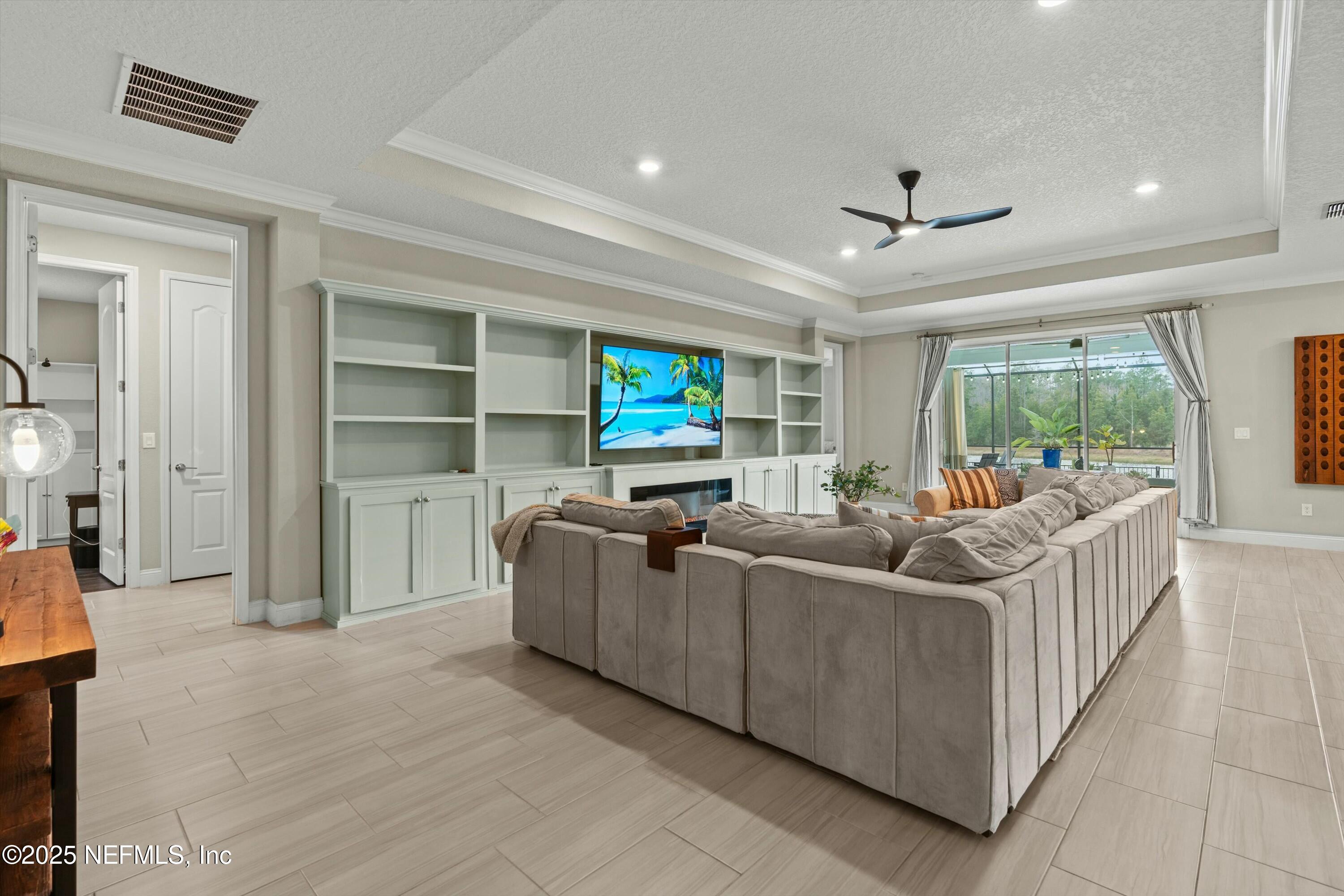 66 Silver Reef Lane St. Augustine, FL 32095 - Photo 12 of 46 a living room with furniture and a flat screen tv