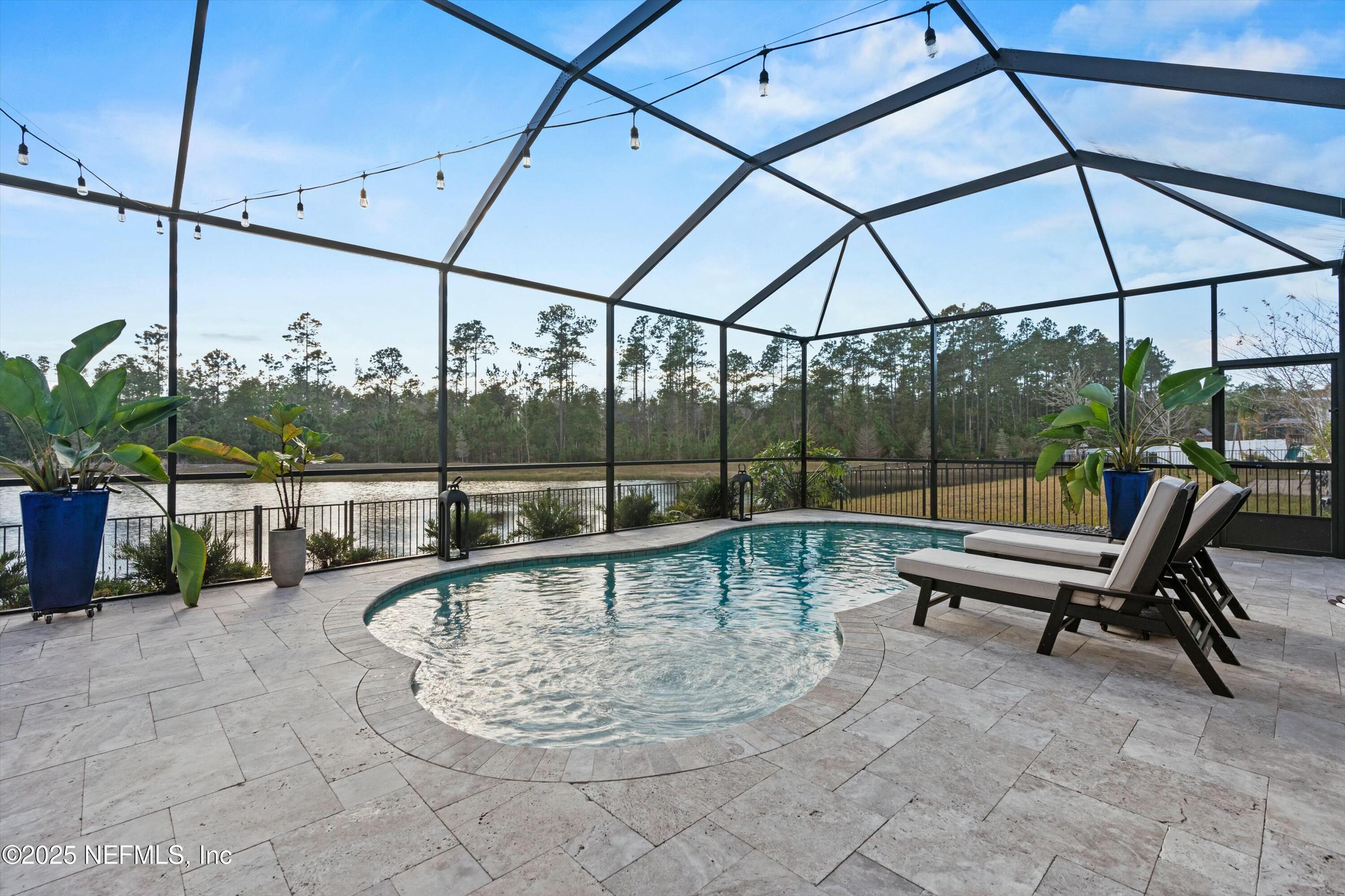 66 Silver Reef Lane St. Augustine, FL 32095 - Photo 18 of 46 a view of a swimming pool with a lounge chair