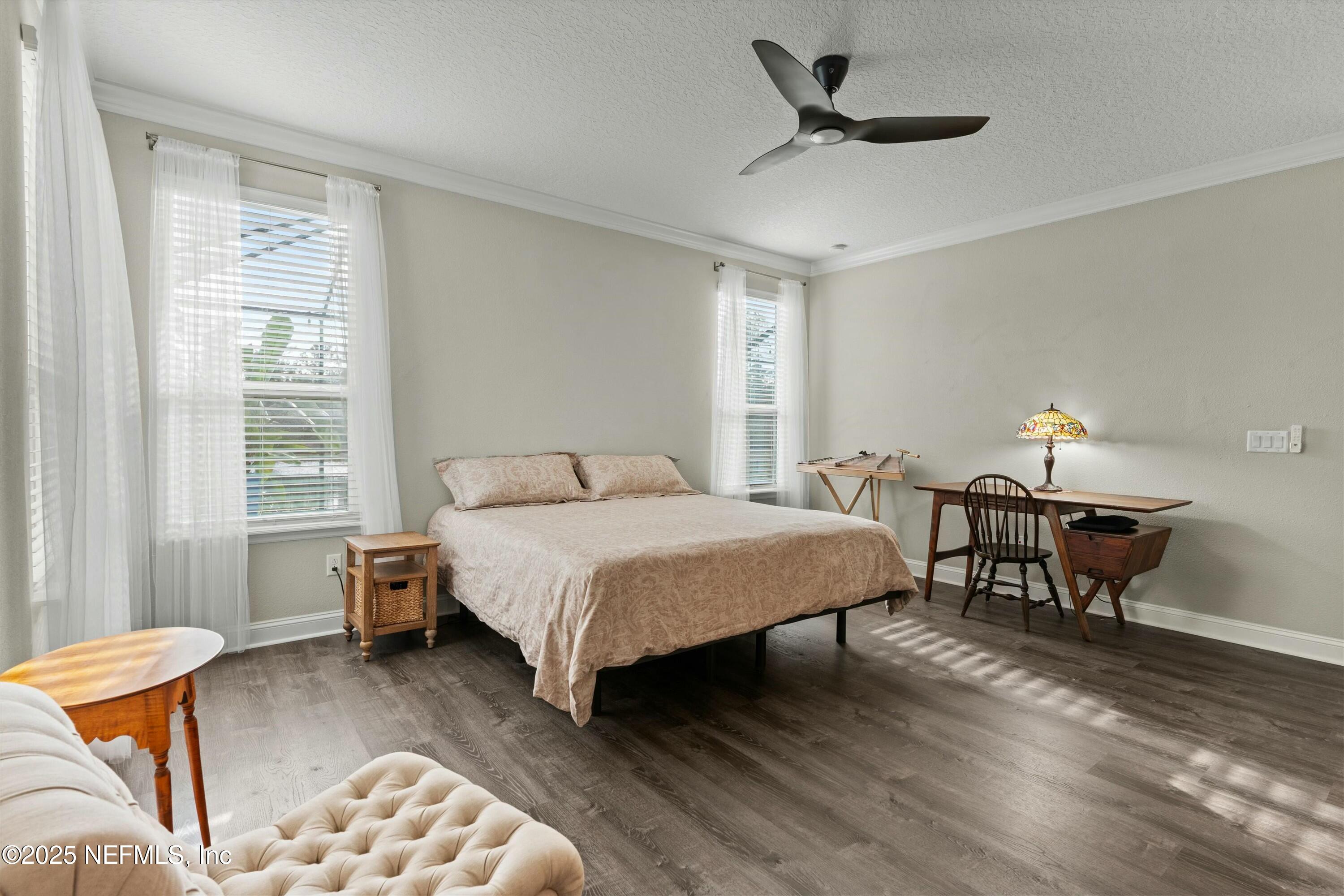 66 Silver Reef Lane St. Augustine, FL 32095 - Photo 24 of 46 a bedroom with a bed and a table in it