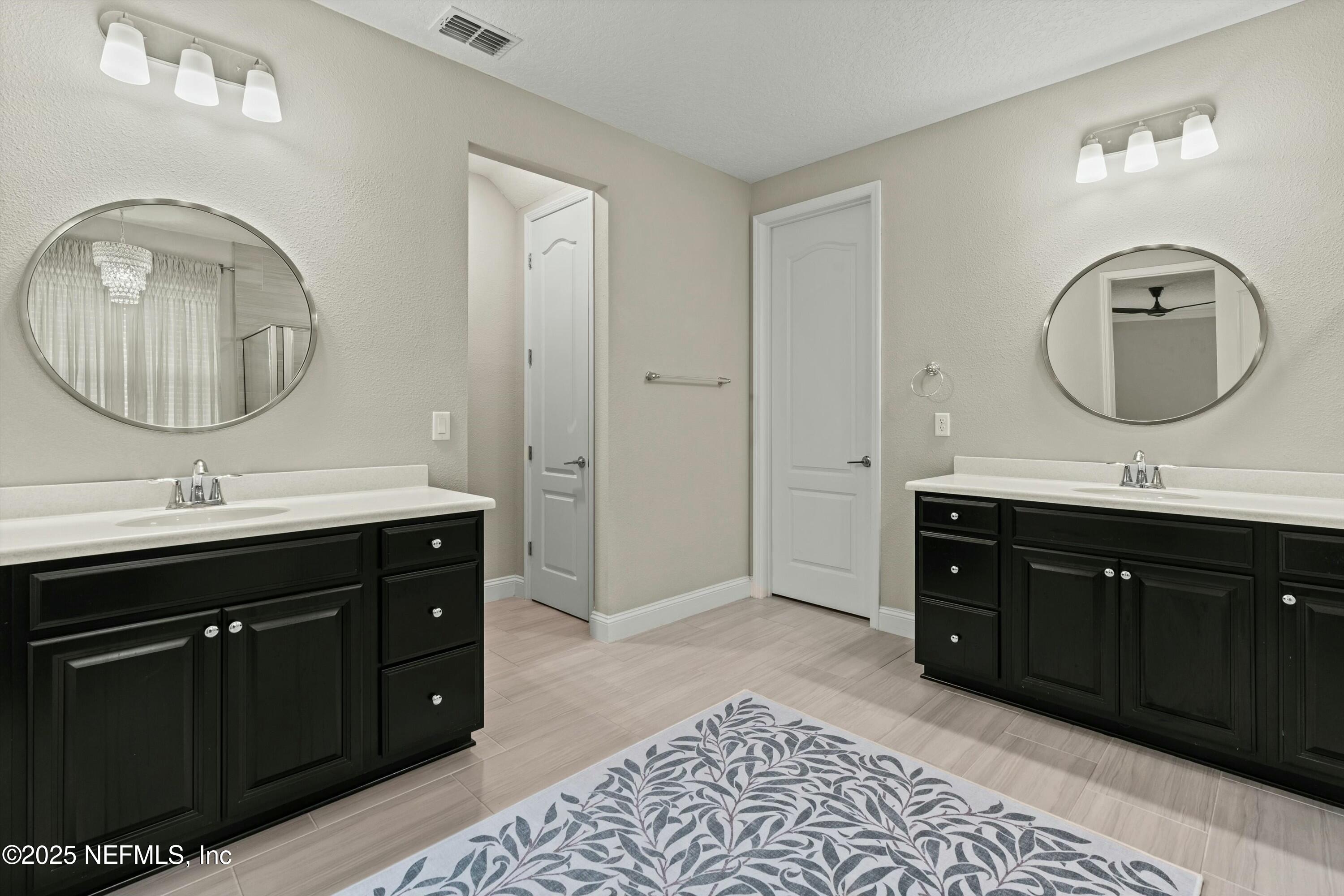 66 Silver Reef Lane St. Augustine, FL 32095 - Photo 26 of 46 a bathroom with a double vanity sink and a mirror