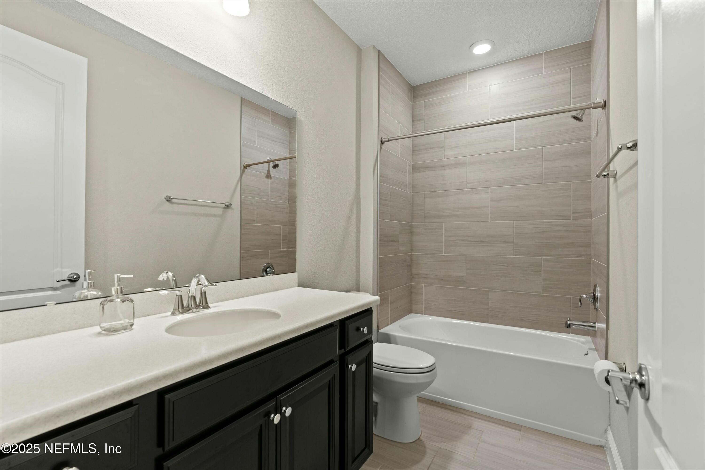 66 Silver Reef Lane St. Augustine, FL 32095 - Photo 30 of 46 a bathroom with a sink a toilet and shower