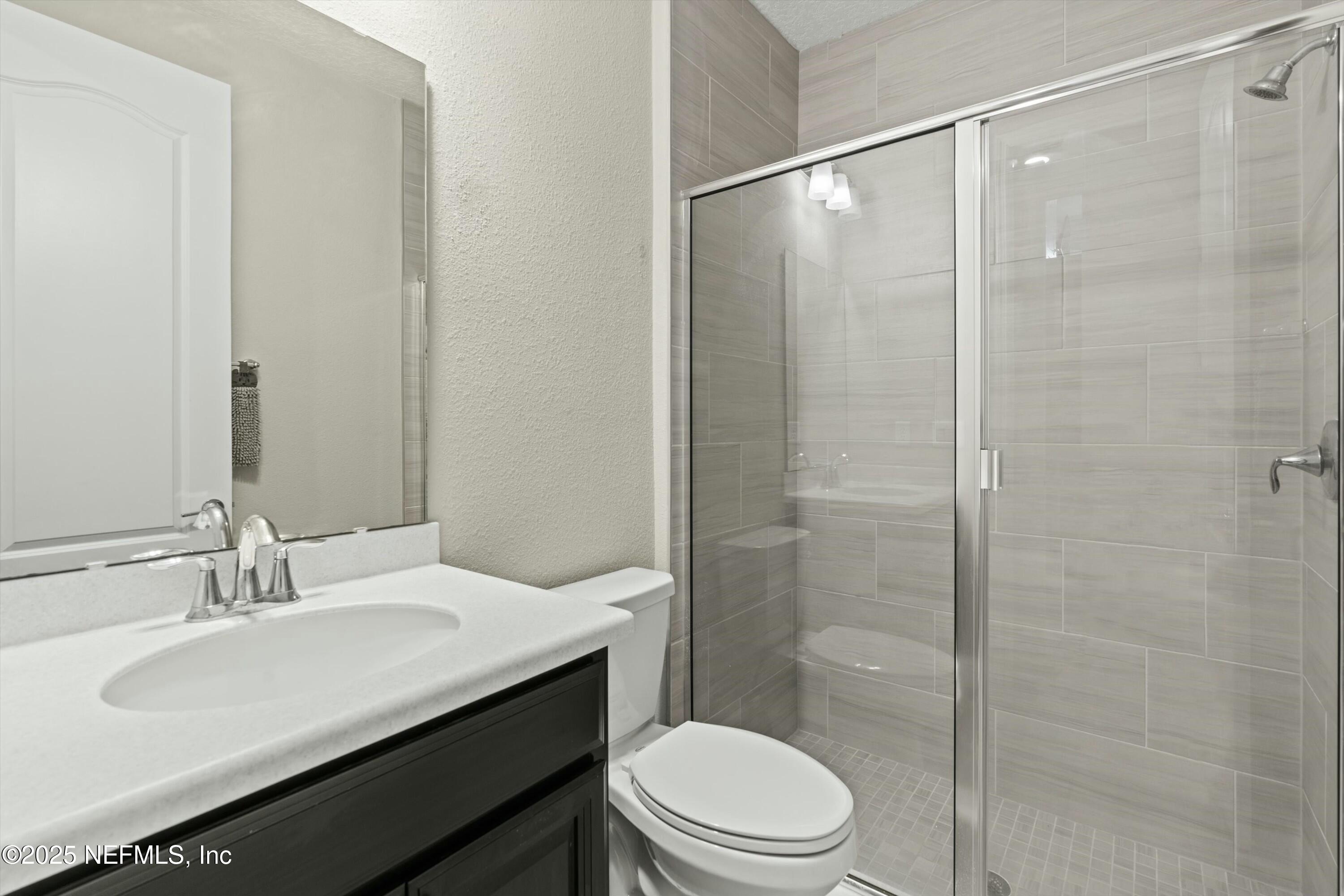 66 Silver Reef Lane St. Augustine, FL 32095 - Photo 32 of 46 a bathroom with a sink a toilet and shower