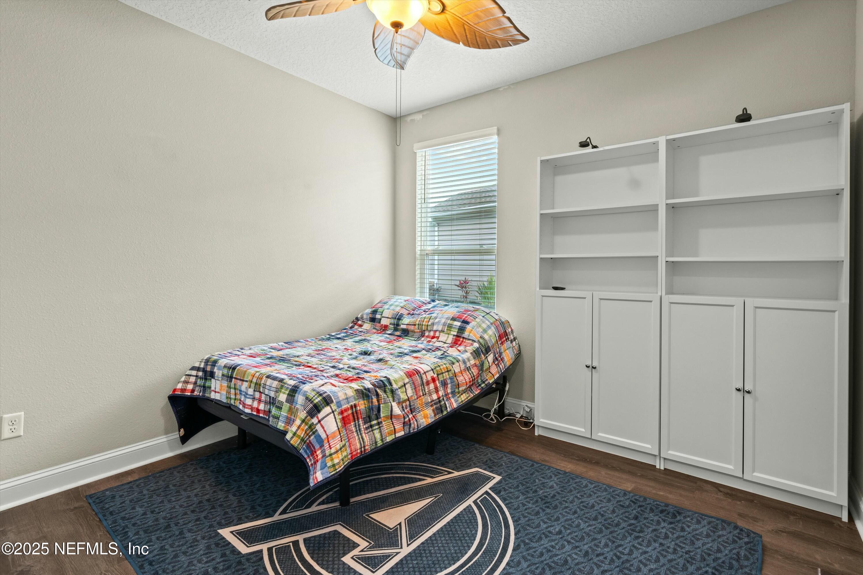 66 Silver Reef Lane St. Augustine, FL 32095 - Photo 33 of 46 a bedroom with a bed and a chandelier