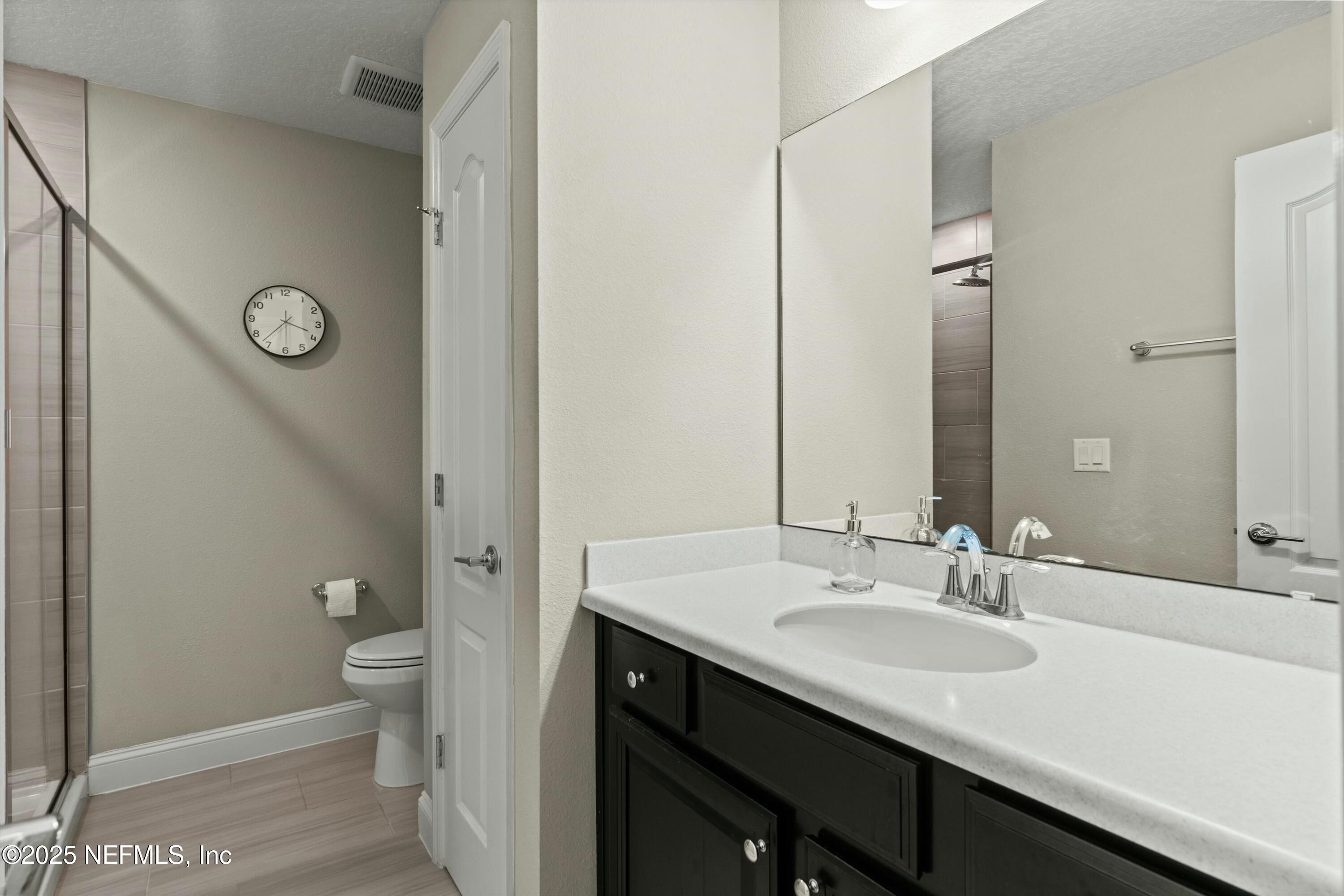 66 Silver Reef Lane St. Augustine, FL 32095 - Photo 37 of 46 a bathroom with a granite countertop sink toilet and shower