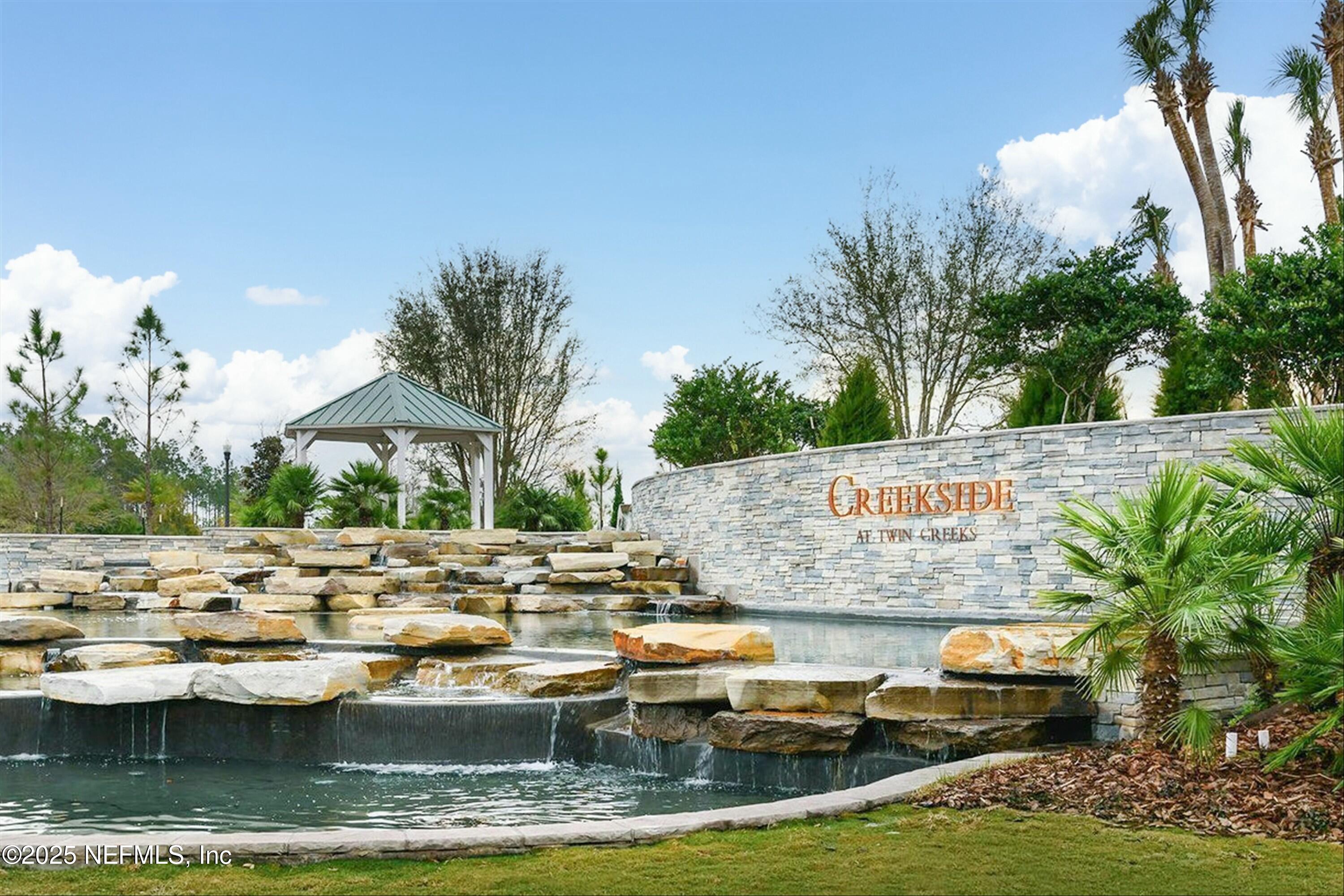 66 Silver Reef Lane St. Augustine, FL 32095 - Photo 40 of 46 a view of swimming pool with outdoor seating and trees in the background