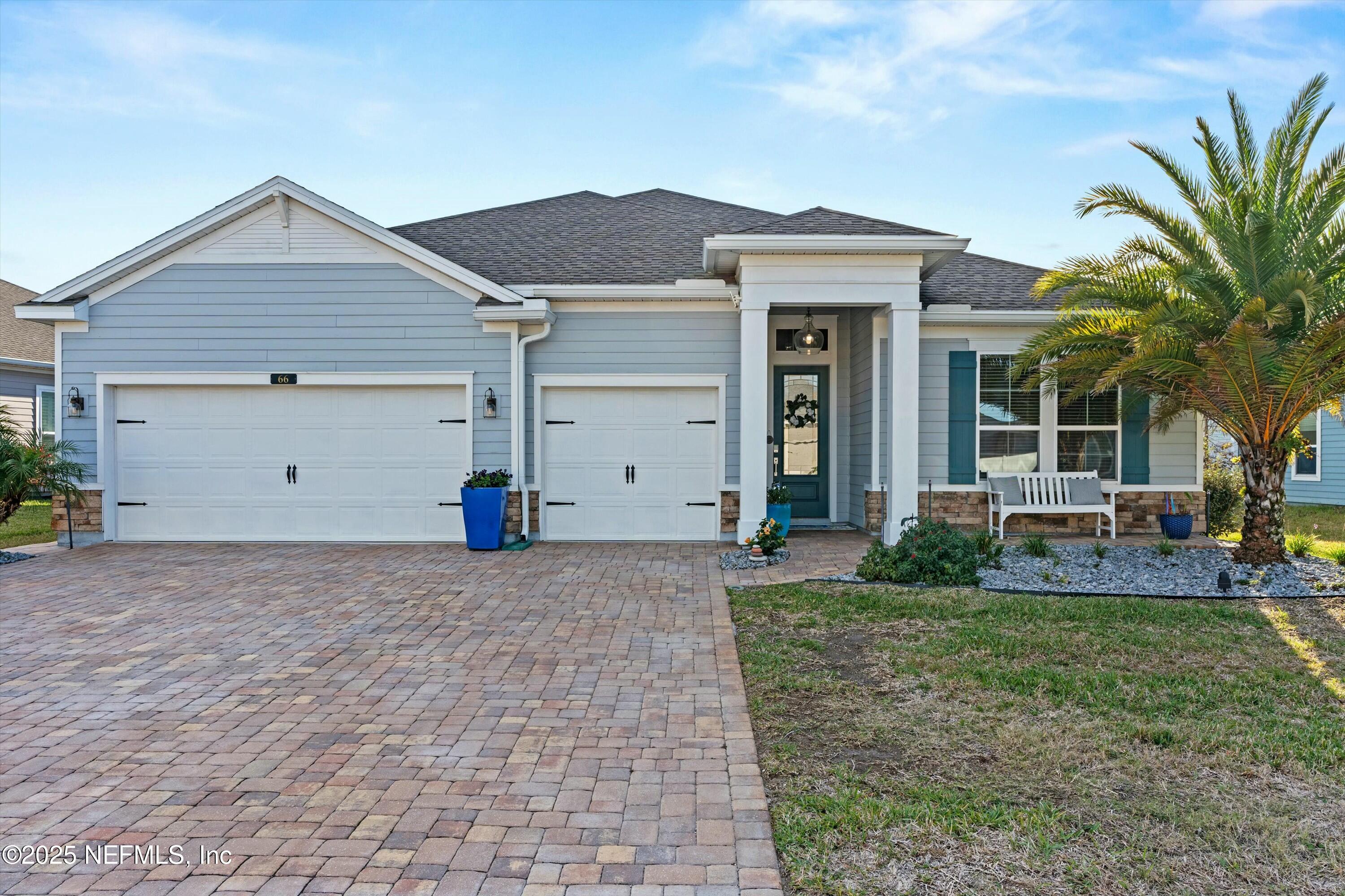 66 Silver Reef Lane St. Augustine, FL 32095 - Photo 4 of 46 a view of a house with a yard and garage
