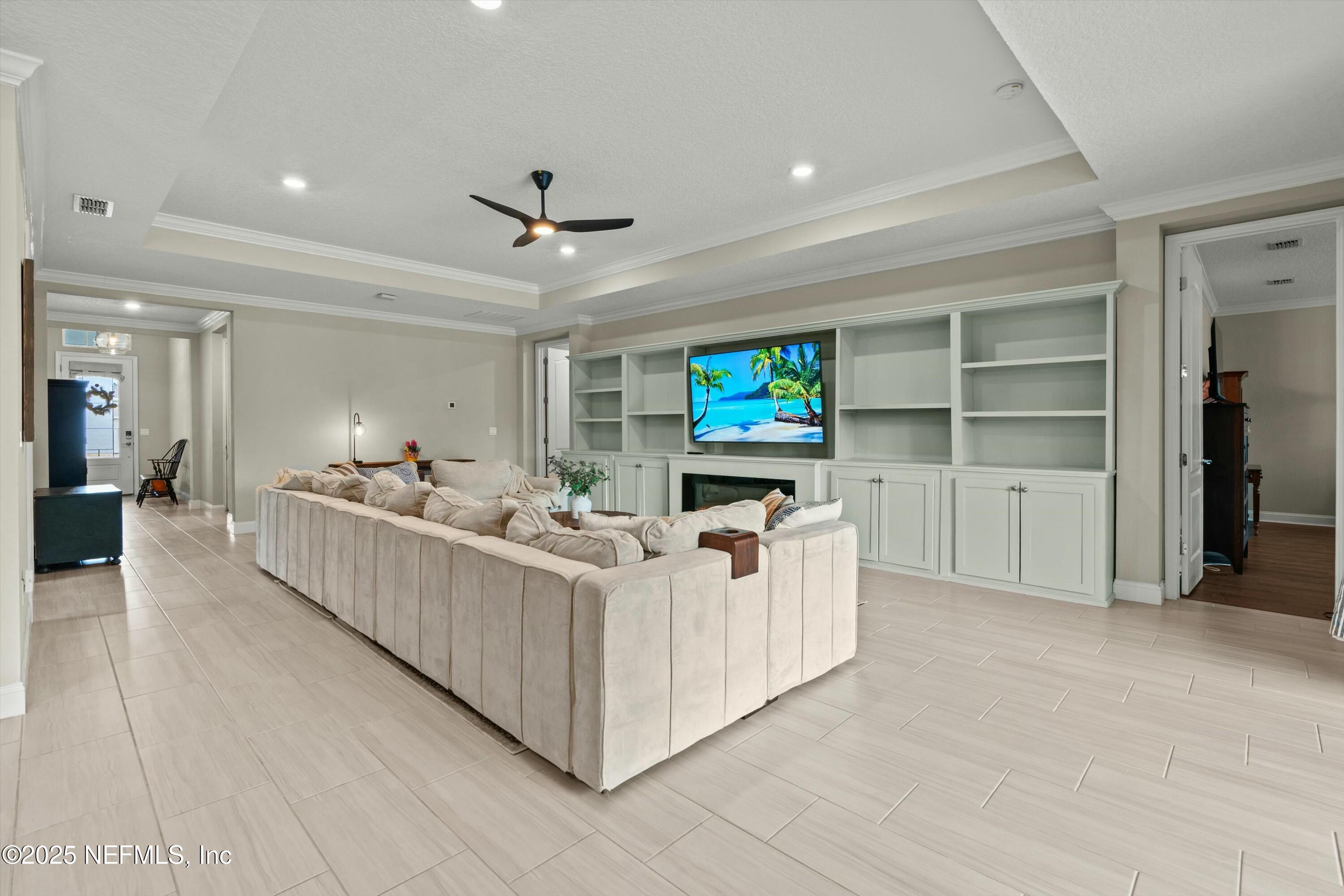 66 Silver Reef Lane St. Augustine, FL 32095 - Photo 7 of 46 a living room with furniture and a flat screen tv