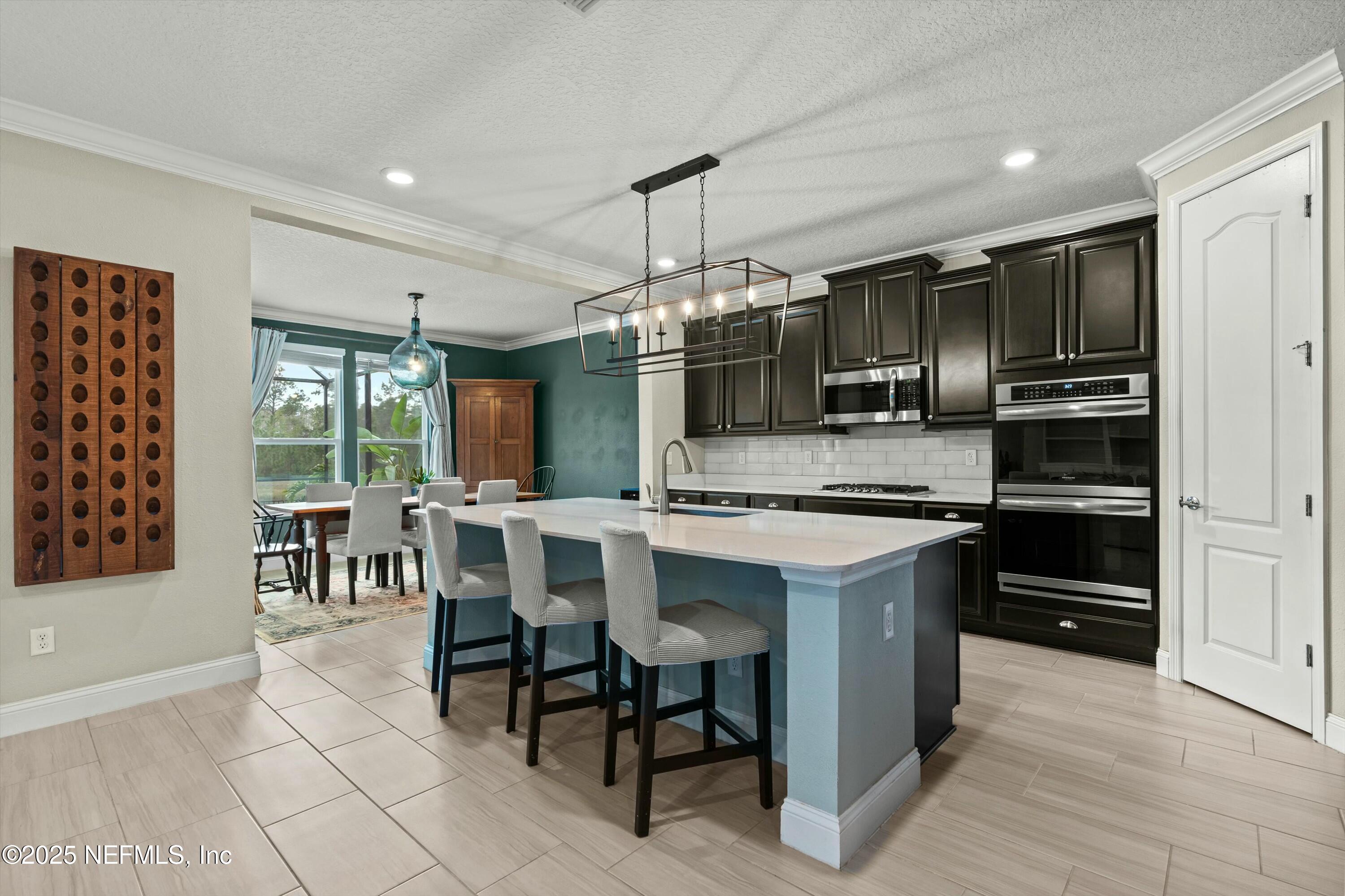 66 Silver Reef Lane St. Augustine, FL 32095 - Photo 8 of 46 a kitchen with kitchen island granite countertop a sink cabinets and stainless steel appliances