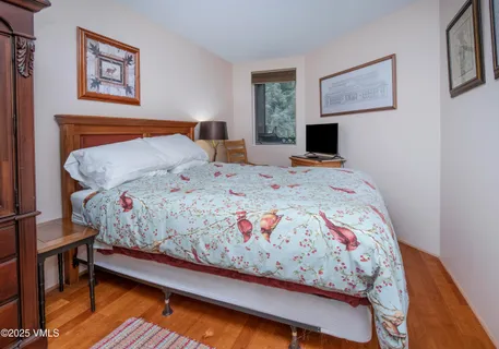 a bedroom with a bed and a desk