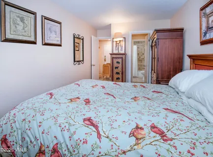 a bedroom with a bed and painting on the wall