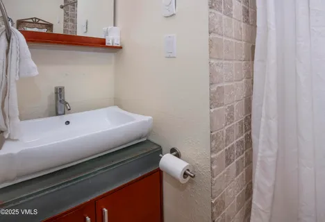 a bathroom with a sink and mirror