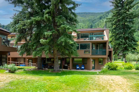 a view of house with a yard