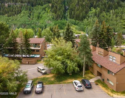 an aerial view of a house with garden space and street view