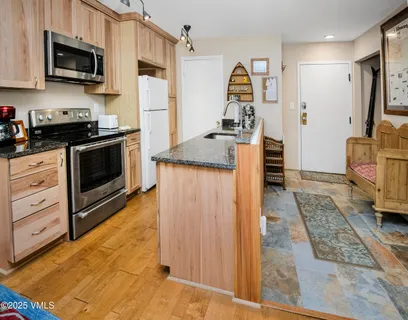 a kitchen with stainless steel appliances granite countertop a stove and a refrigerator