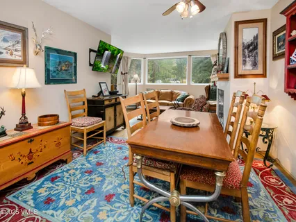 a view of a dining room with furniture and chandelier