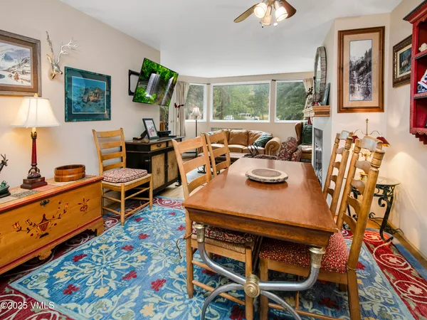 a view of a dining room with furniture and chandelier