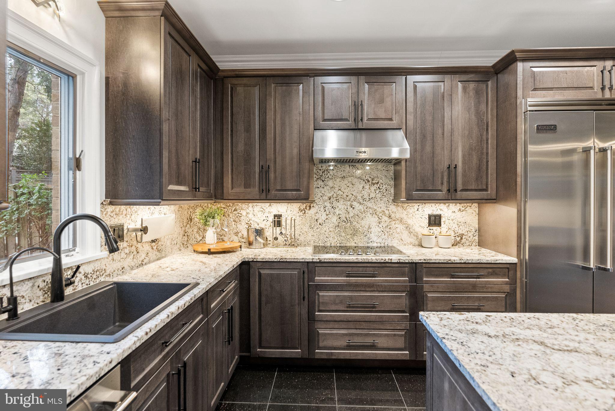 4613 Charleston Terrace Northwest Washington, DC 20007 - Photo 22 of 114 a kitchen with kitchen island granite countertop a sink stainless steel appliances and cabinets