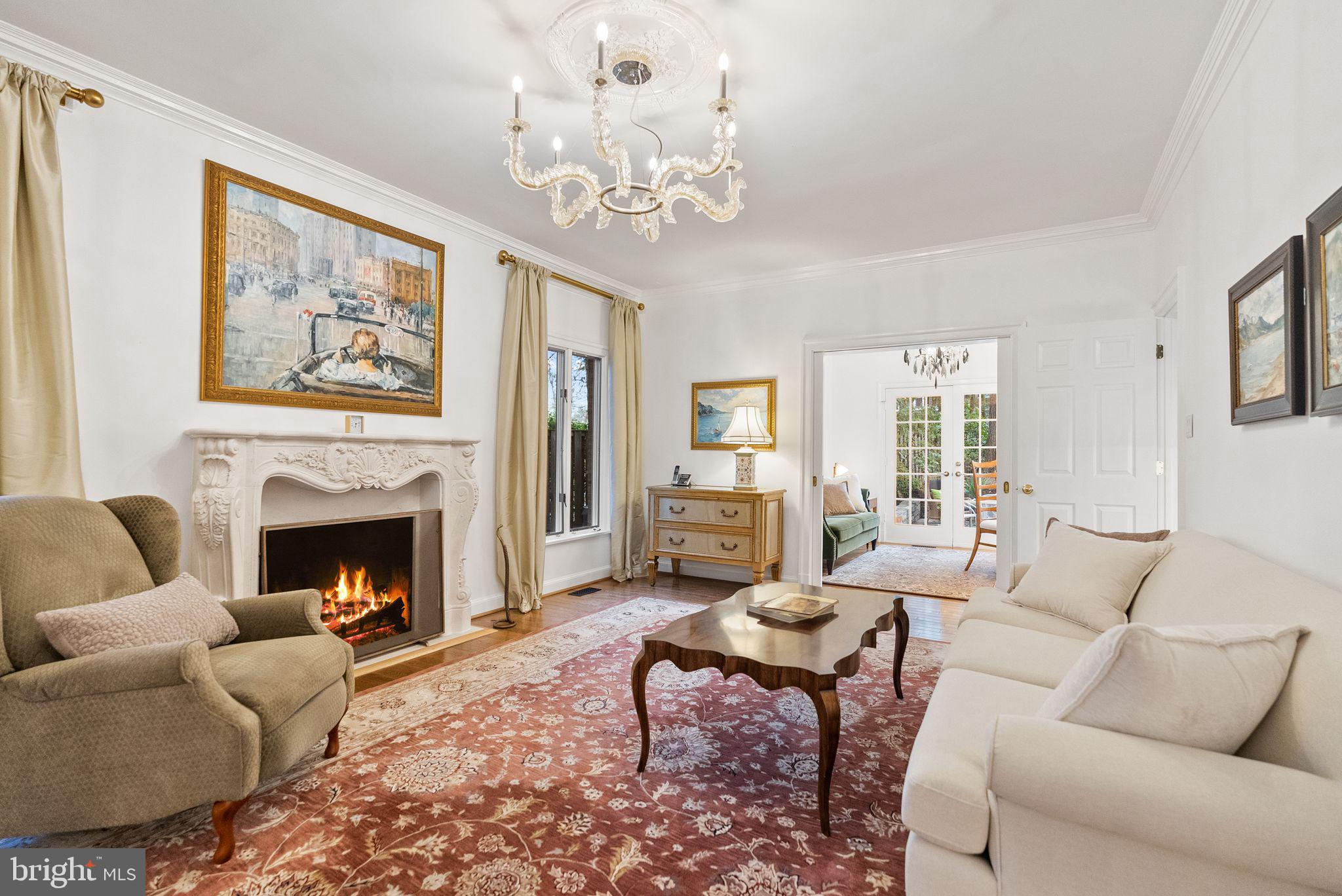 4613 Charleston Terrace Northwest Washington, DC 20007 - Photo 29 of 114 a living room with furniture a chandelier and a fireplace