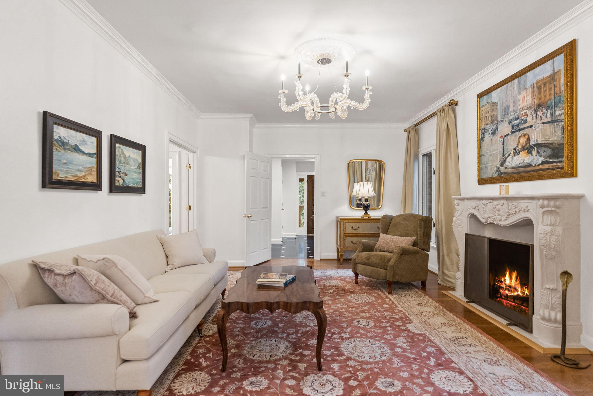 4613 Charleston Terrace Northwest Washington, DC 20007 - Photo 30 of 114 a living room with furniture a chandelier and a fireplace