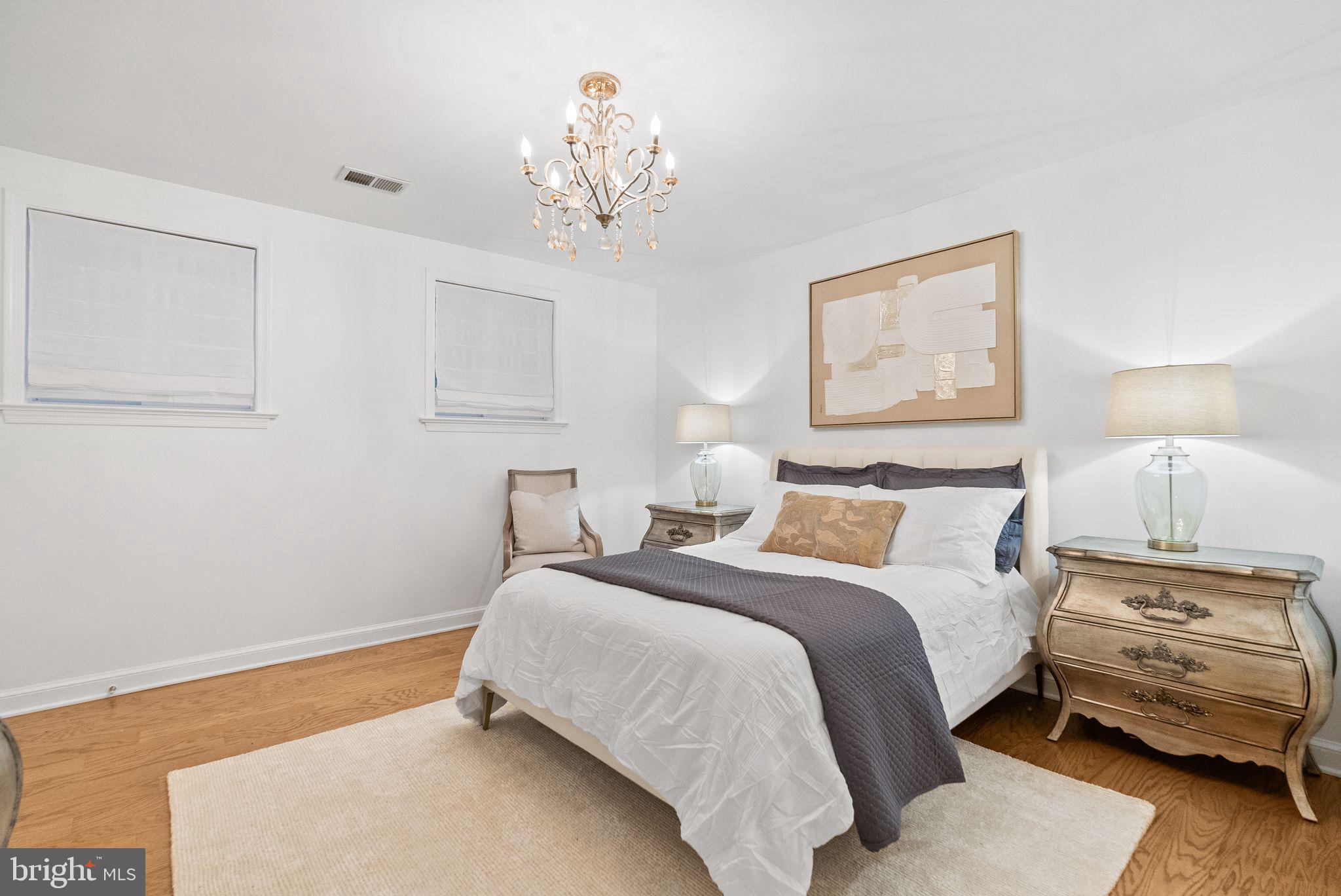 4613 Charleston Terrace Northwest Washington, DC 20007 - Photo 74 of 114 a bedroom with a bed and a chandelier