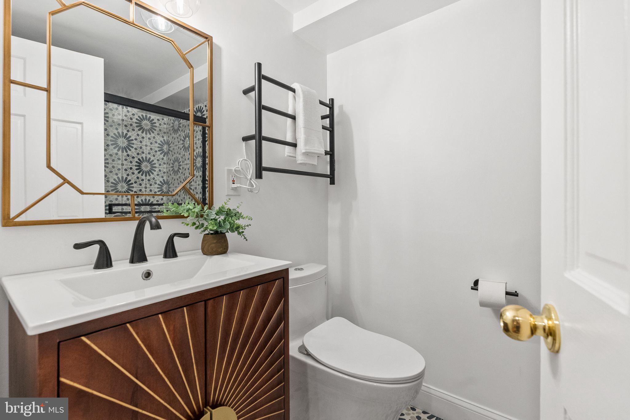4613 Charleston Terrace Northwest Washington, DC 20007 - Photo 76 of 114 a bathroom with a sink a toilet and mirror