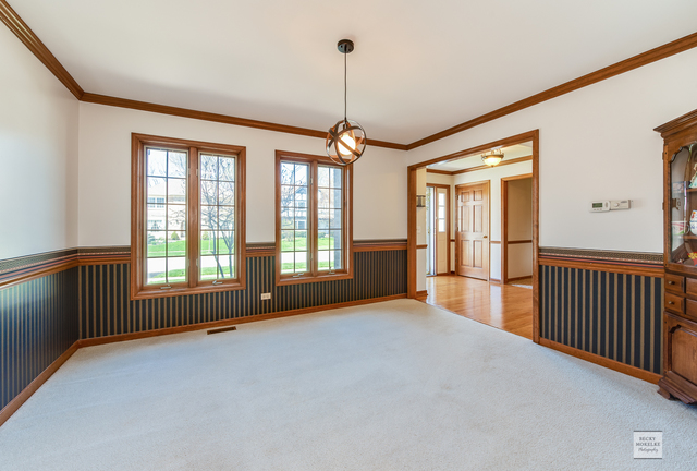 1812 Denison Road Naperville, IL 60565 - Photo 5 of 33 a view of empty room with wooden floor and fan