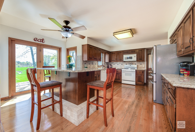 1812 Denison Road Naperville, IL 60565 - Photo 8 of 33 a view of a dining room with furniture window and wooden floor