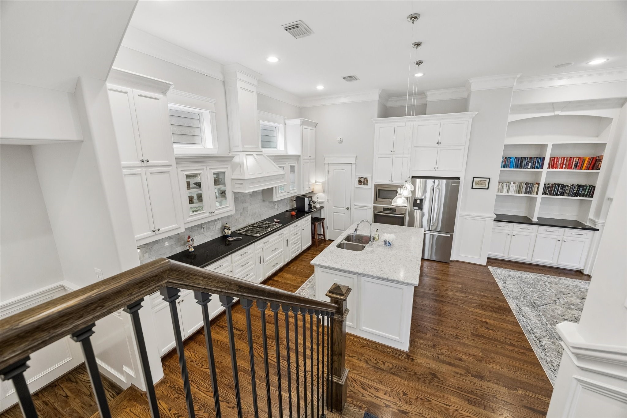609 Rutland Street, Unit A Houston, TX 77007 - Photo 21 of 30 a open kitchen with stainless steel appliances kitchen island granite countertop a refrigerator a stove and white cabinets with wooden floor