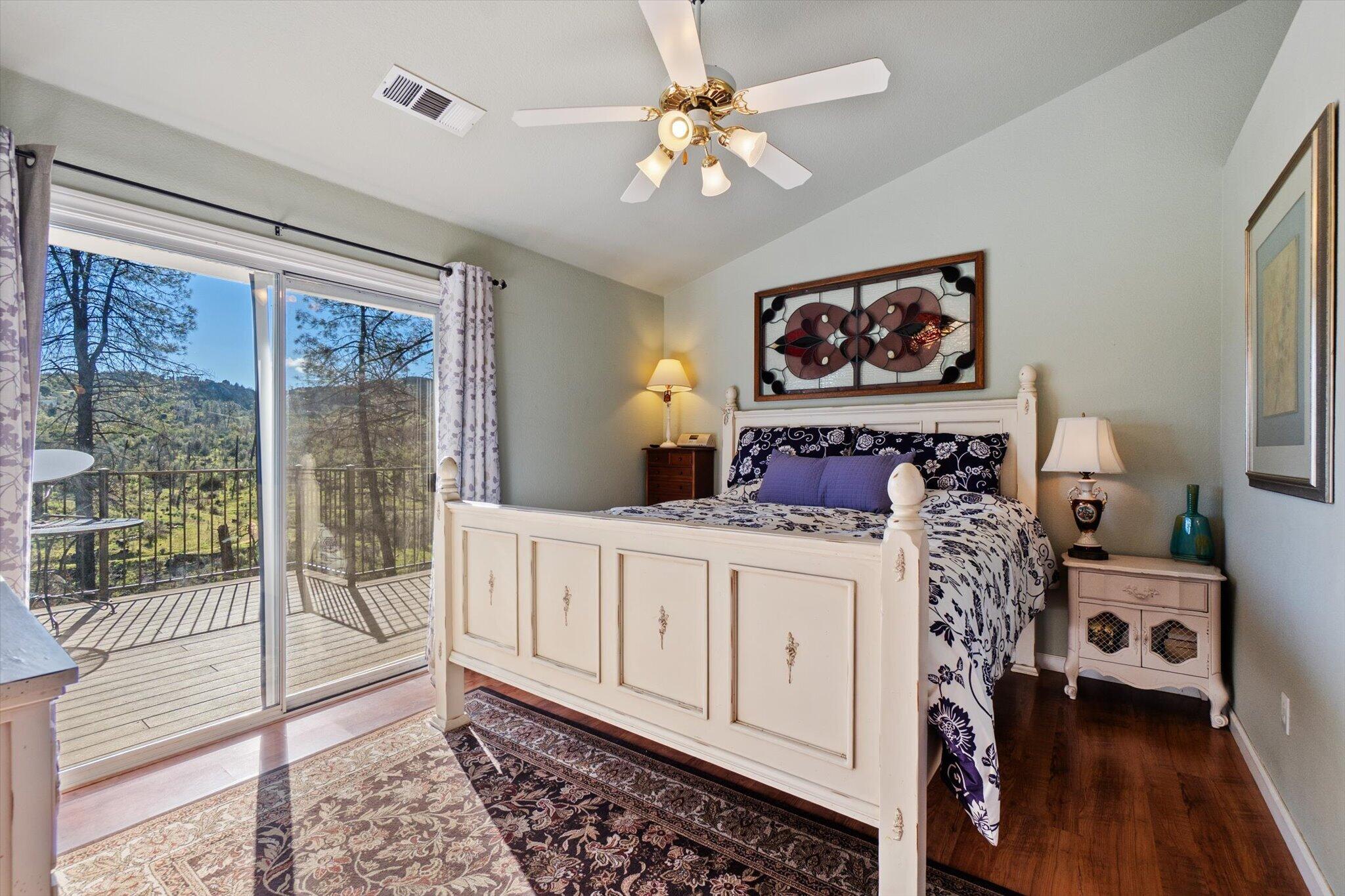 10067 Tilton Mine Road Redding, CA 96001 - Photo 12 of 62 a bedroom with furniture and wooden floor