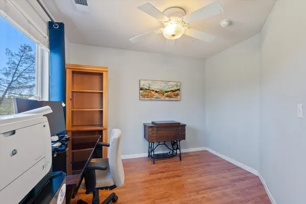 a bathroom with a granite countertop sink a toilet and a mirror