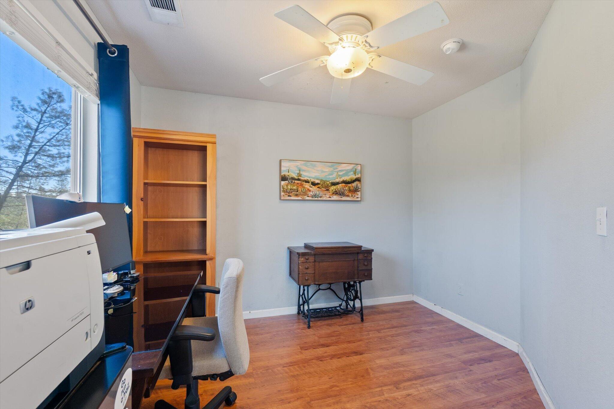 10067 Tilton Mine Road Redding, CA 96001 - Photo 17 of 62 a view of a workspace with furniture and a window