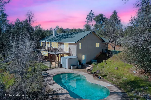 a front view of a house with a yard fire pit and outdoor seating