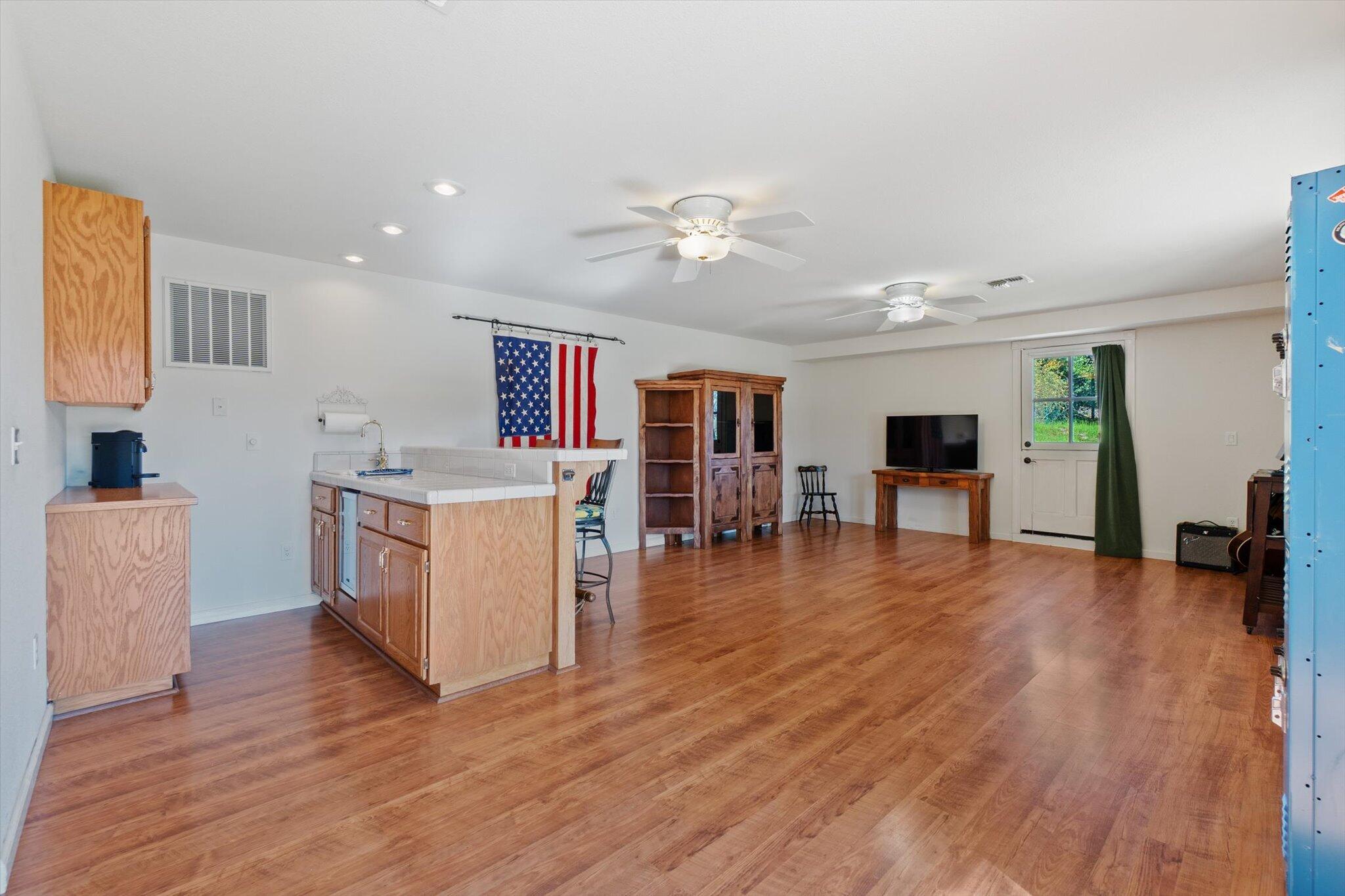 10067 Tilton Mine Road Redding, CA 96001 - Photo 23 of 62 a living room with furniture and a wooden floor