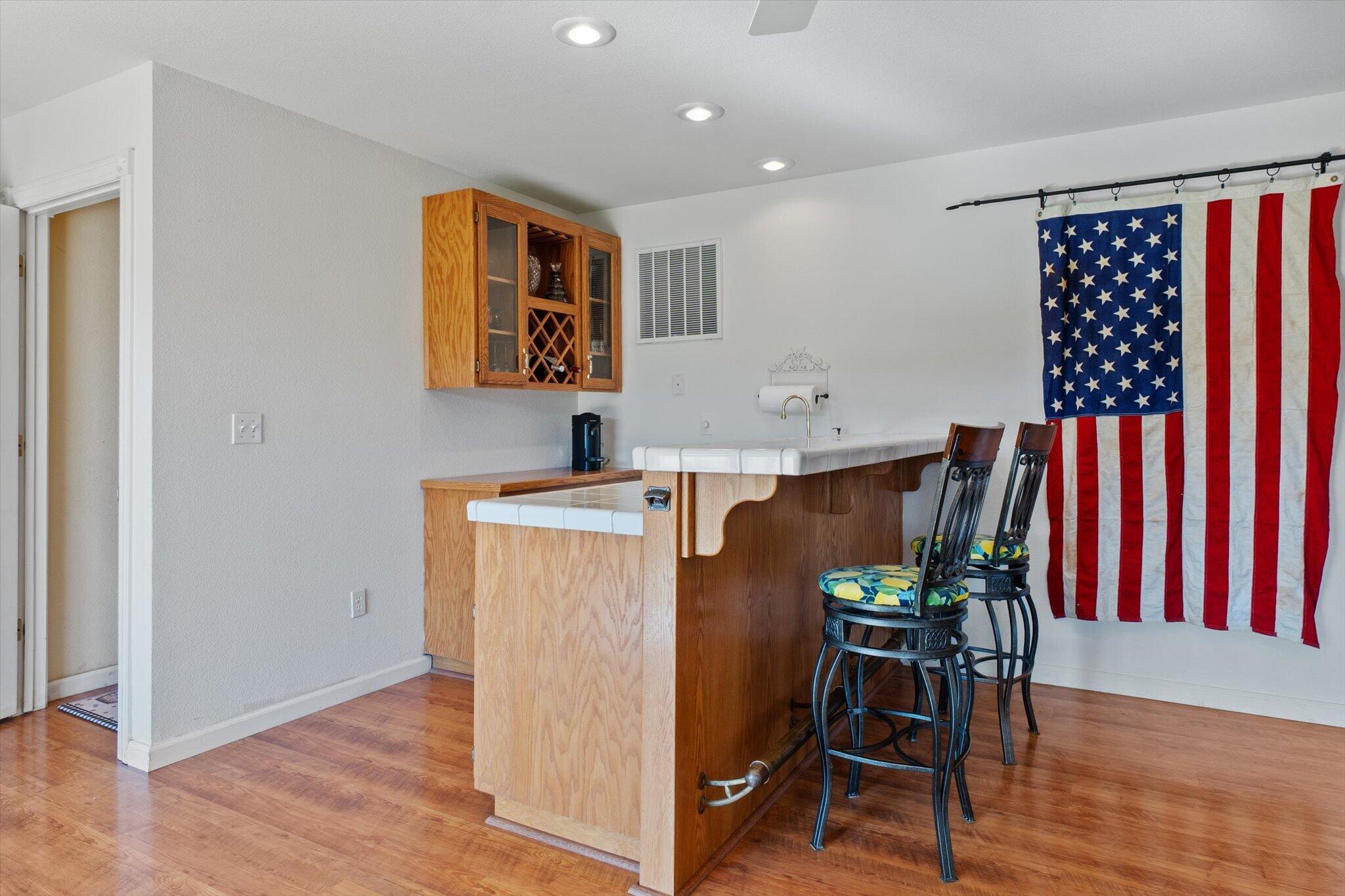 10067 Tilton Mine Road Redding, CA 96001 - Photo 24 of 62 a workspace with furniture and wooden floor
