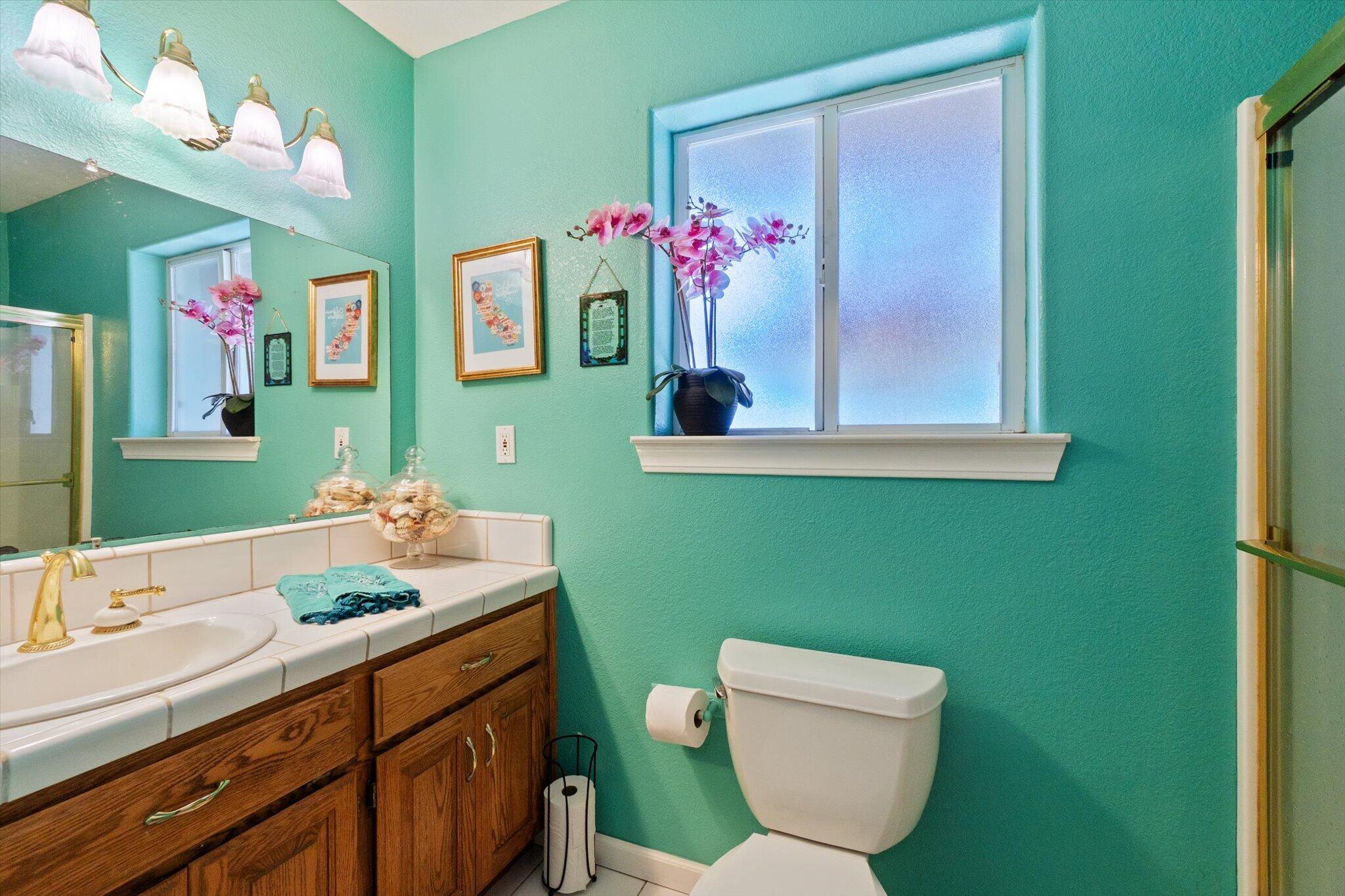 10067 Tilton Mine Road Redding, CA 96001 - Photo 28 of 62 a bathroom with a toilet sink and mirror