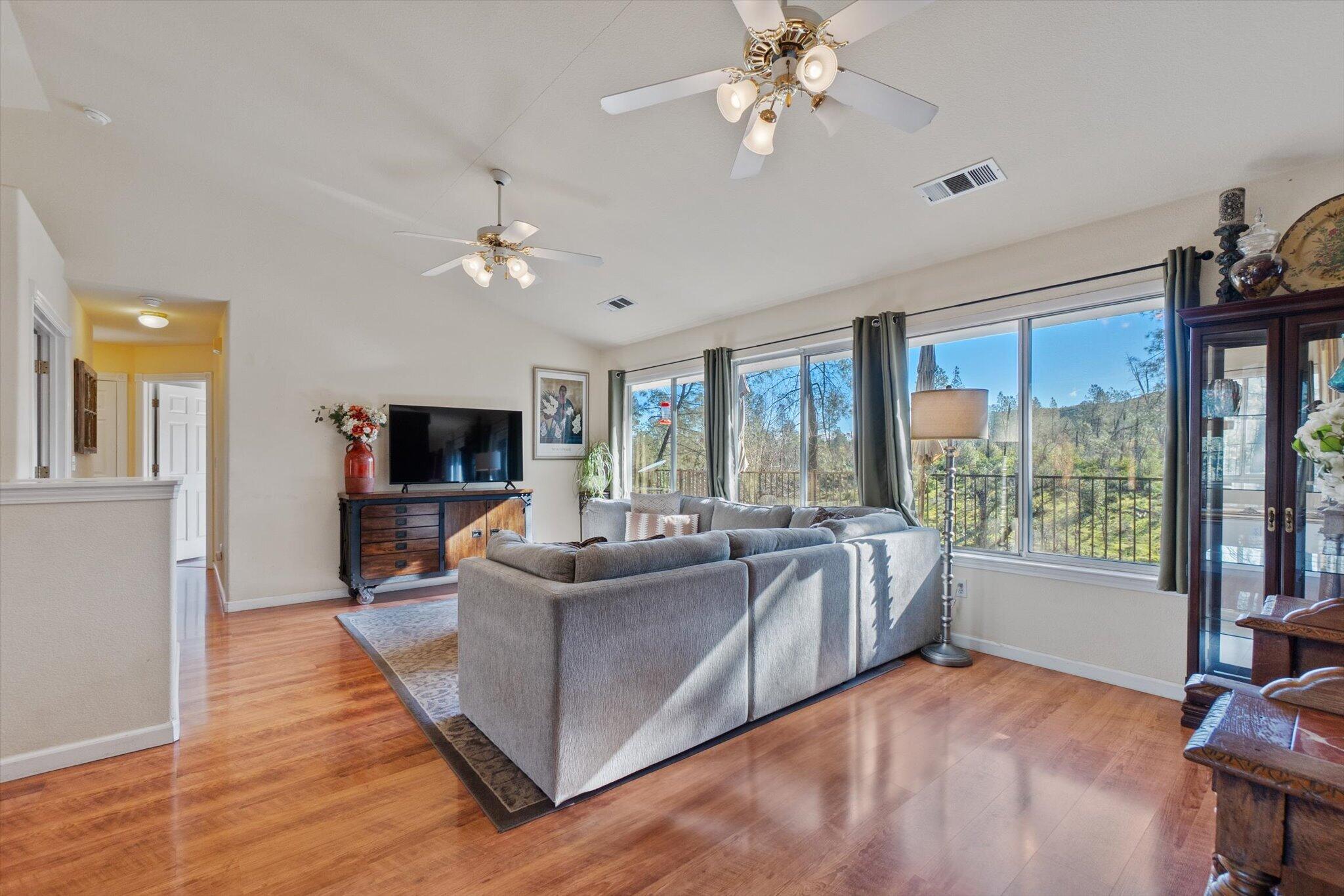 10067 Tilton Mine Road Redding, CA 96001 - Photo 5 of 62 a living room with furniture a flat screen tv and a large window