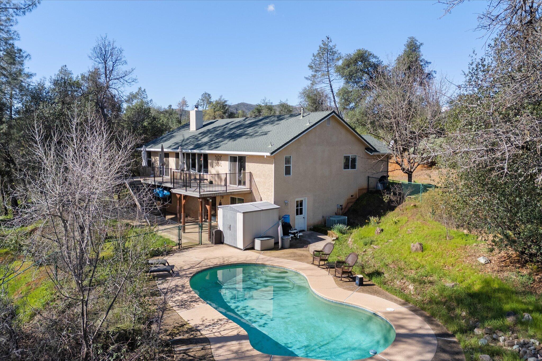 10067 Tilton Mine Road Redding, CA 96001 - Photo 57 of 62 a view of house with outdoor space and trees around