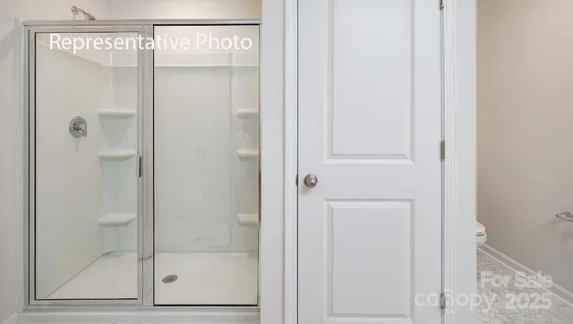 a bathroom with a glass shower door