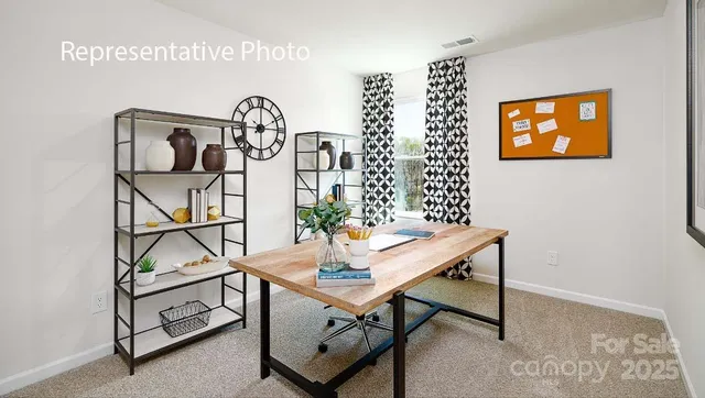 a view of a room that has a table and a wall paintings