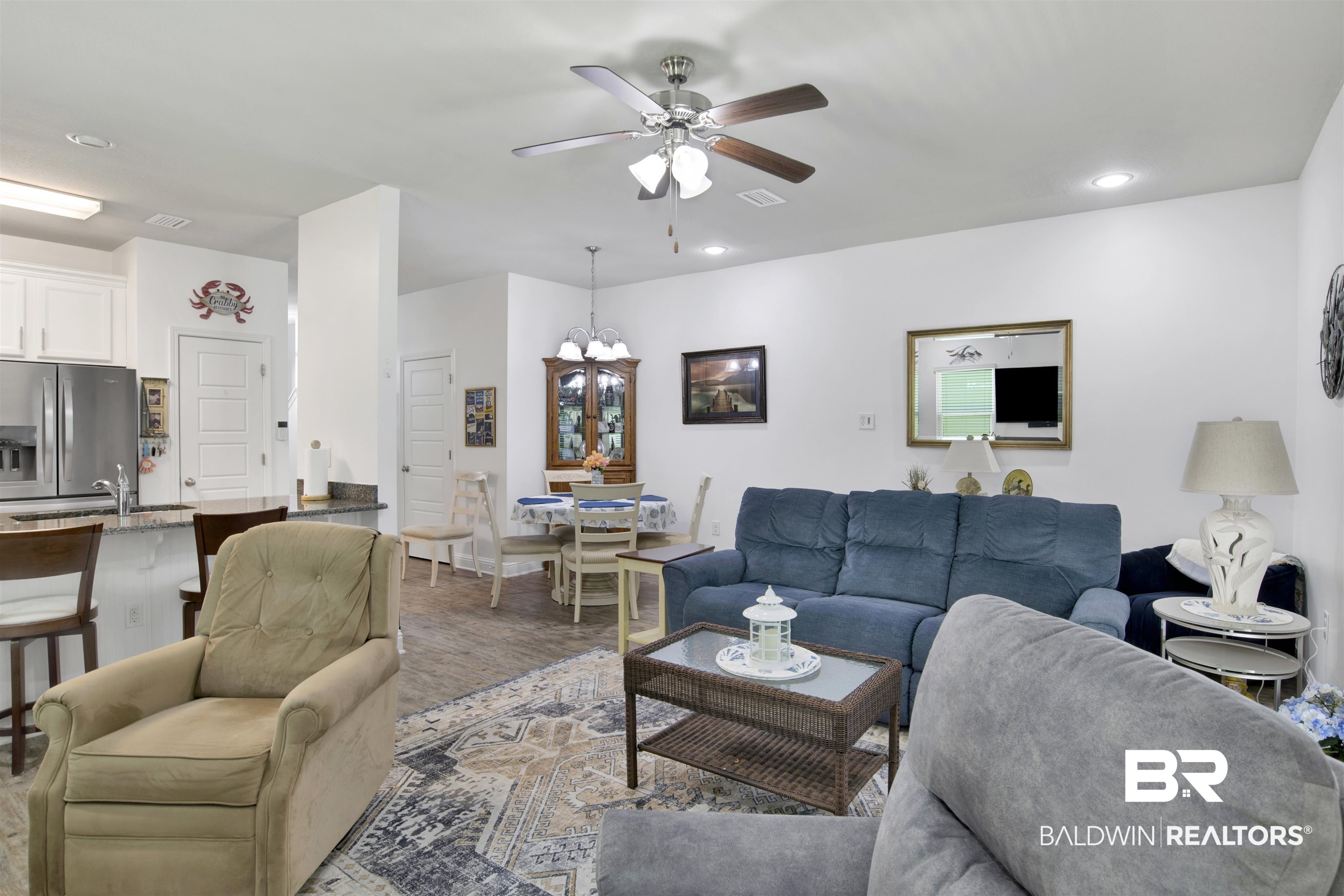 25806 Pollard Road, Unit 20 Daphne, AL 36526 - Photo 11 of 29 Living room with ceiling fan with notable chandelier, hardwood / wood-style floors, and sink
