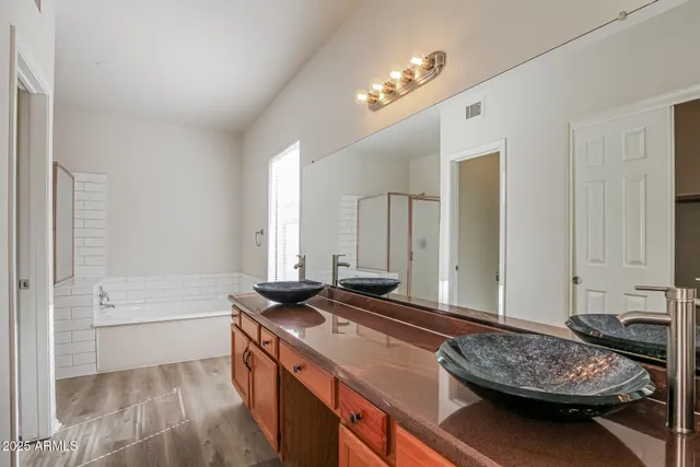 a spacious bathroom with a sink a bathtub and a mirror
