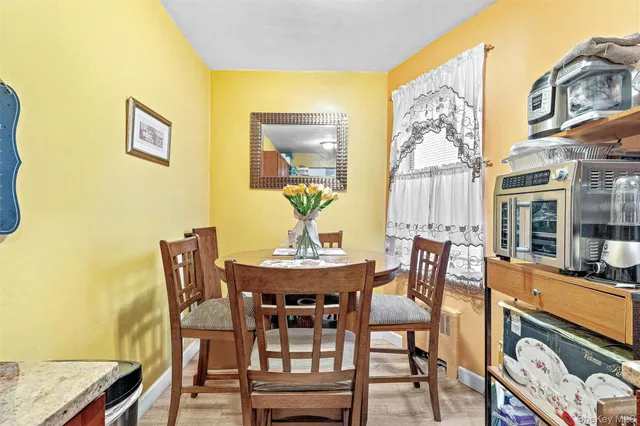 a view of a dining room with furniture and chandelier