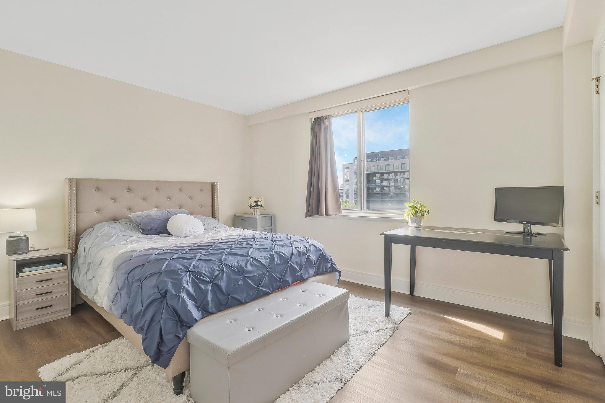 800 4th Street Southwest, Unit S721 Washington, DC 20024 - Photo 18 of 39 a spacious bedroom with a bed and a table