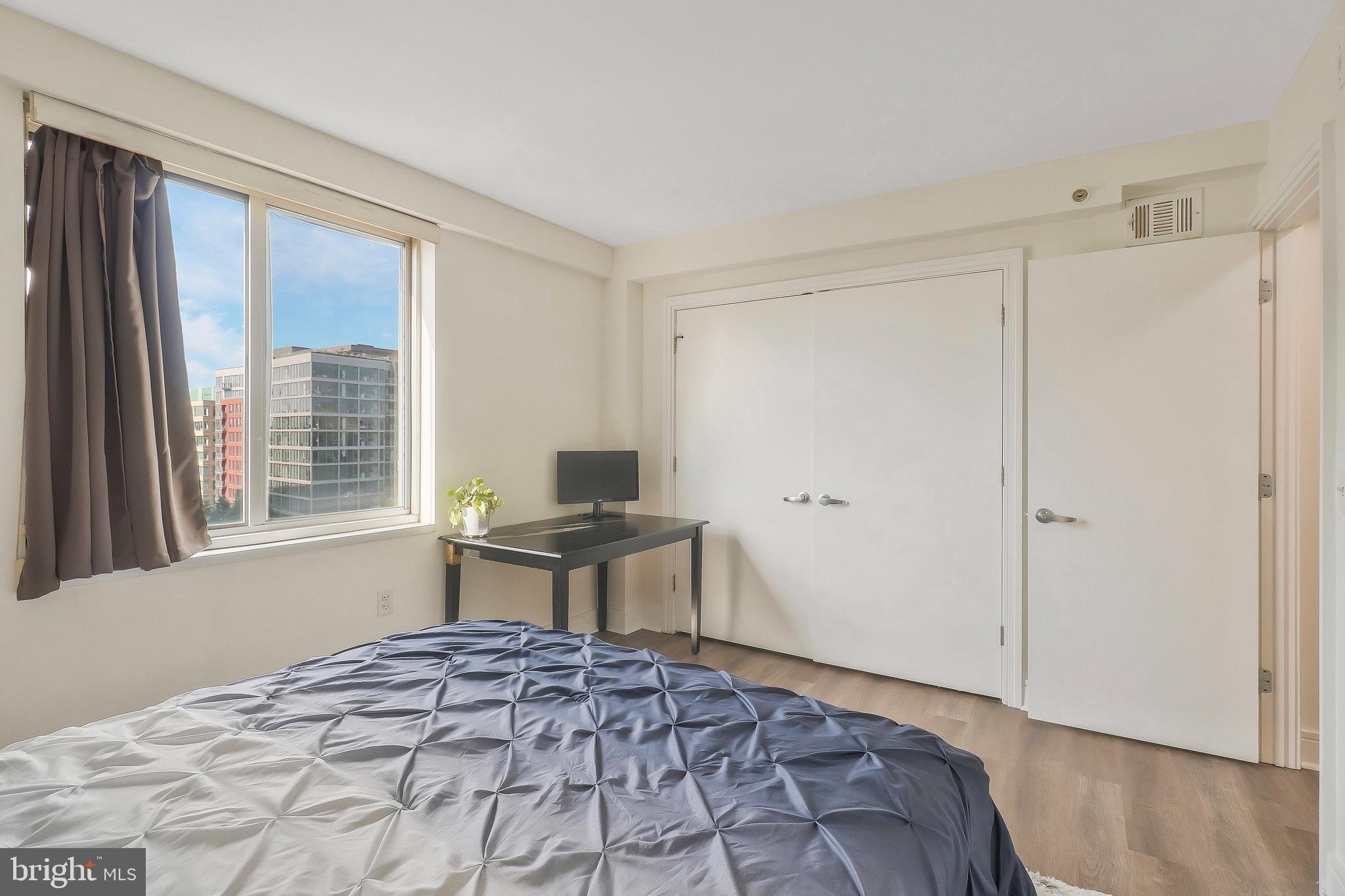 800 4th Street Southwest, Unit S721 Washington, DC 20024 - Photo 20 of 39 a bedroom with a bed and a window