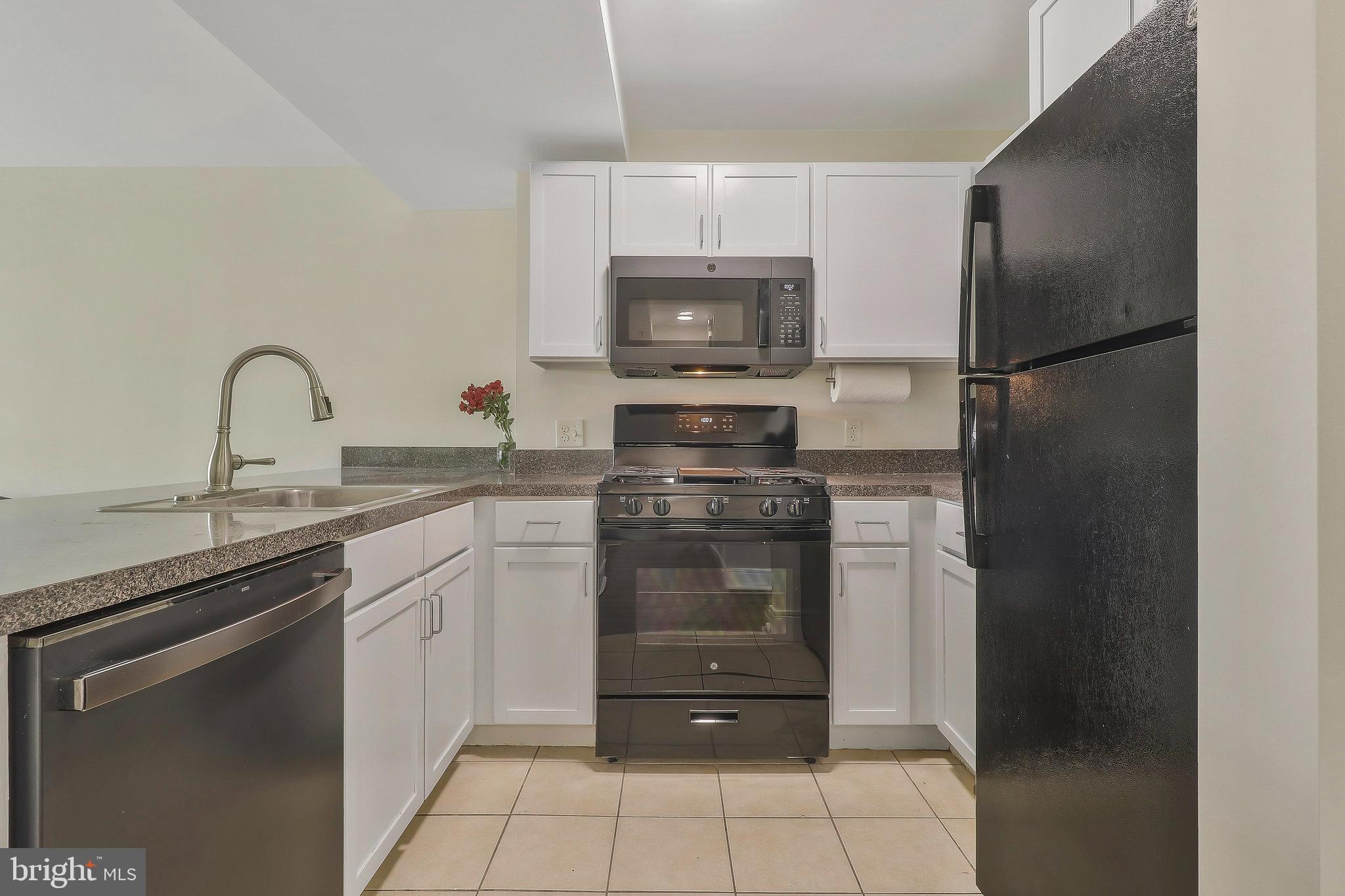 800 4th Street Southwest, Unit S721 Washington, DC 20024 - Photo 7 of 39 a kitchen with a refrigerator and a sink