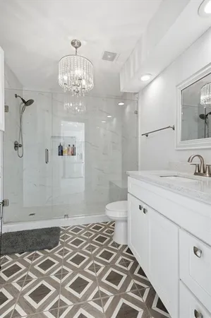 a bathroom with a sink toilet and shower