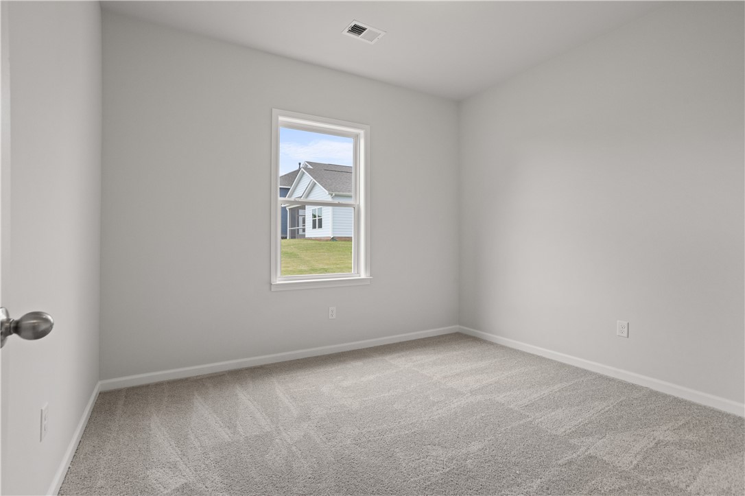 555 Hydrangea Street, Unit LOT 47 Seneca, SC 29678 - Photo 17 of 38 Comfortable carpet and pristine white walls define this inviting bedroom.